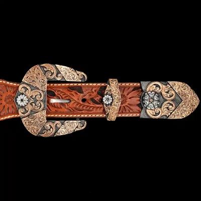 A custom western three piece belt buckle set featuring copper scrollwork